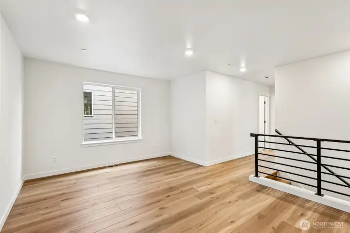 LVP plank extends up the stairs and into the loft area with the matching upgraded handrailing - perfect spot for everyone to gather!