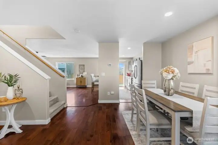 Open concept kitchen, dining and living room with vinyl plank flooring