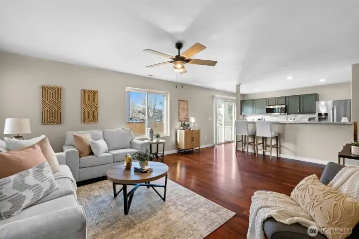 Living room opens to kitchen and looks out to backyard