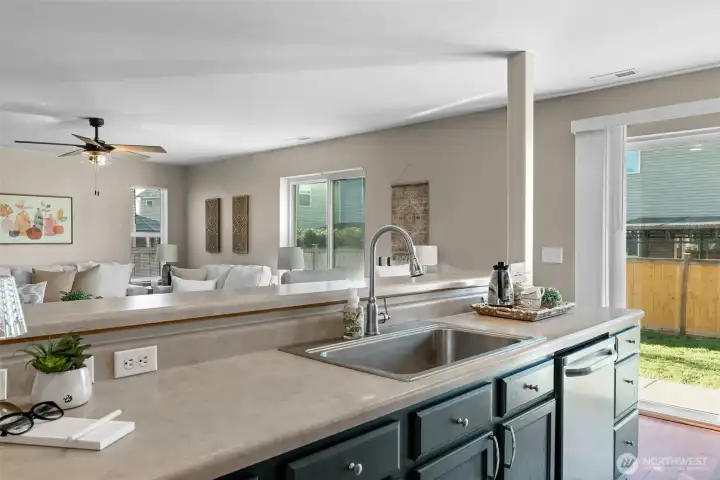 Kitchen looks out to living room