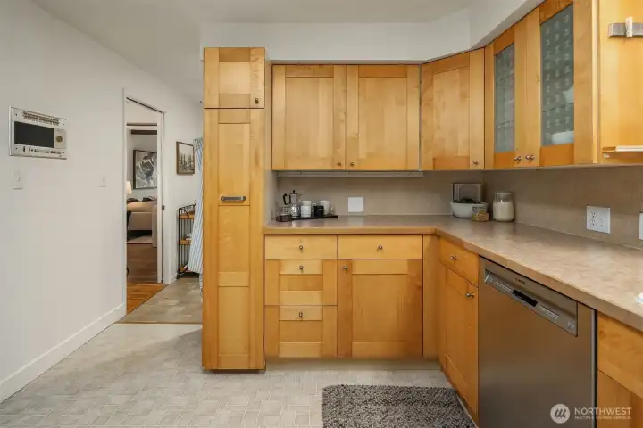 Generous cabinetry, tall pull-out pantry, and smart storage throughout.