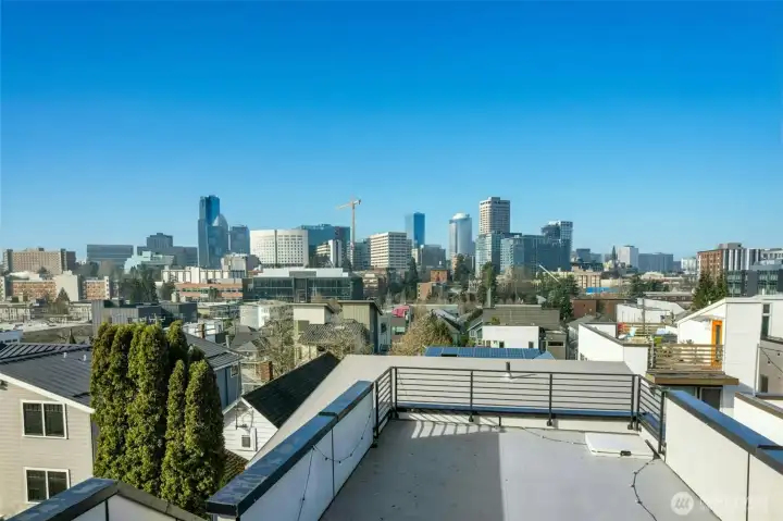 A spectacular rooftop deck captures sweeping panoramic views of the Seattle skyline
