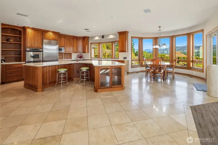 This is a "WOW" kitchen with views all around! High end appliances, Stadium sized kitchen island, lots for storage, Travertine floors, and adjacent to the family room and with double glass doors to the covered outdoor living area.