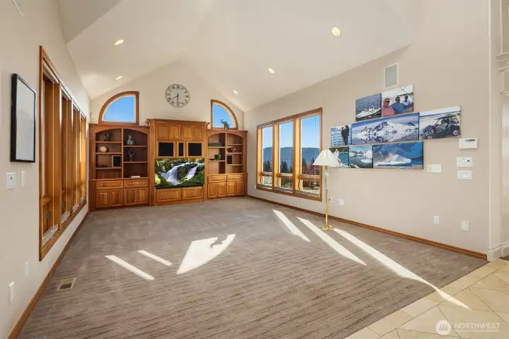 Large family room with a 14' tall, vaulted ceiling and a spacious entertainment center!