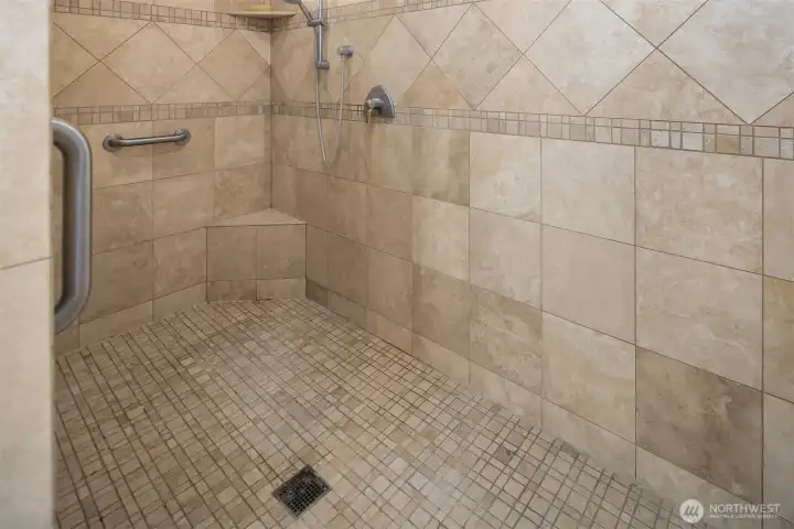 Walk-in 4+' X 8+' tile shower with dual shower controls.