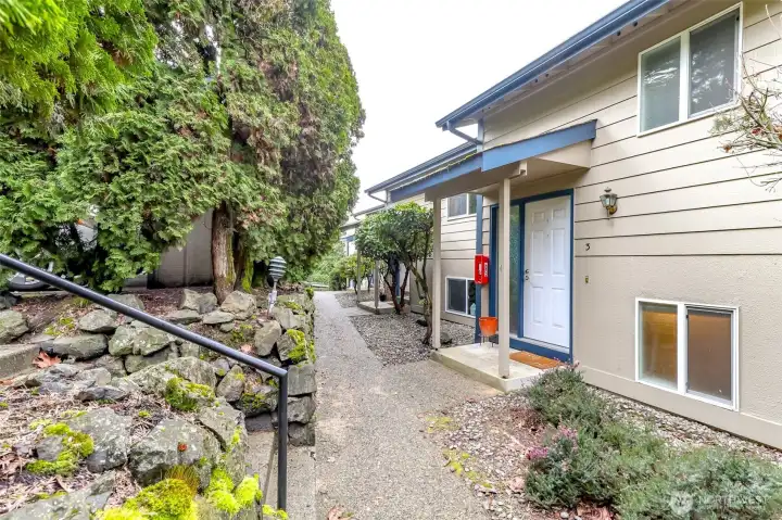 Front entrance to condo. To the left of the stairs is the back parking lot, designated carpet space and storage unit at the end of the carpet.