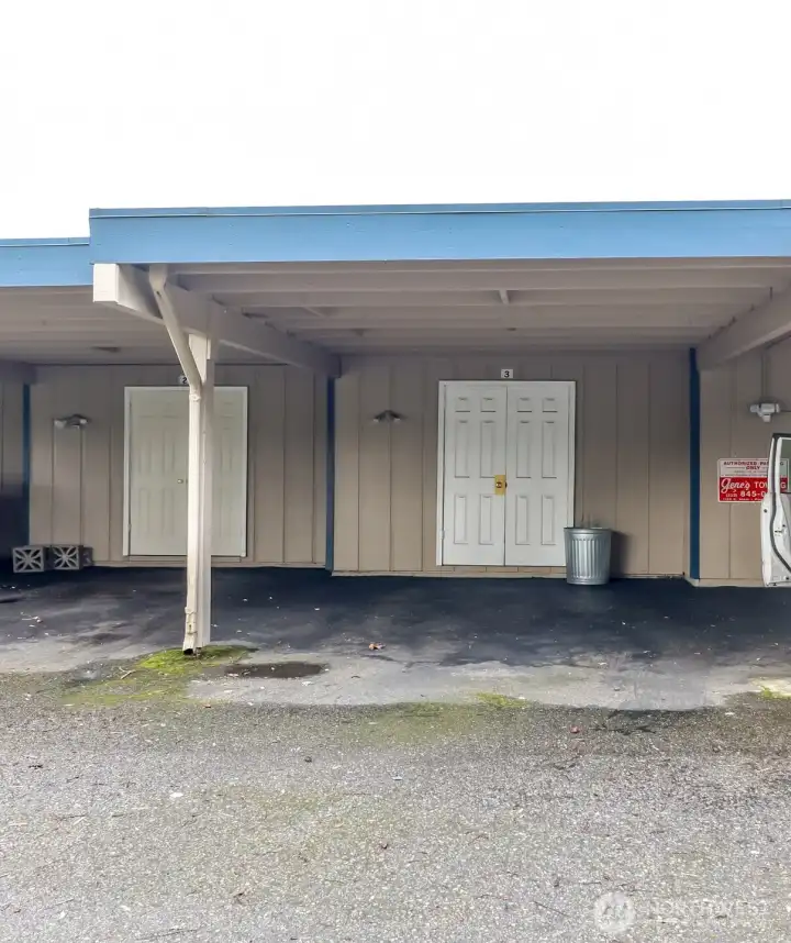 Designated carpet parking for unit #3 with storage shed for added convenience.