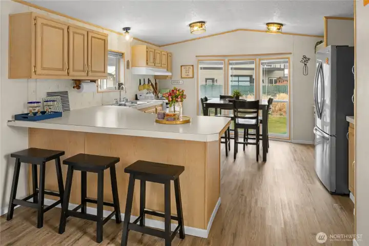 Kitchen with eating space that looks onto backyard