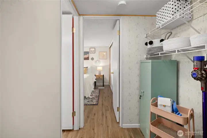 hallway leading to bedrooms with washer hook up on the right