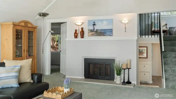 Propane gas fireplace, door on left leads to the Primary Suite