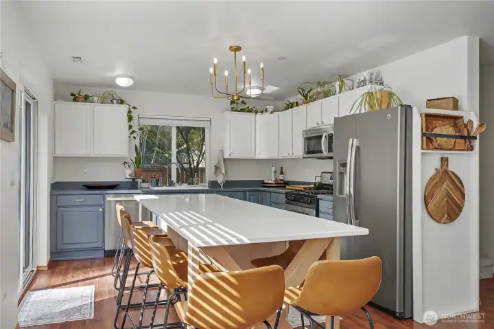 Refreshed kitchen with quartz counters, stainless appliances and gas range.