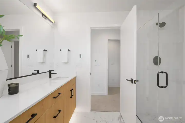 Spa-inspired primary bathroom featuring a walk-in glass shower and modern vanity.
