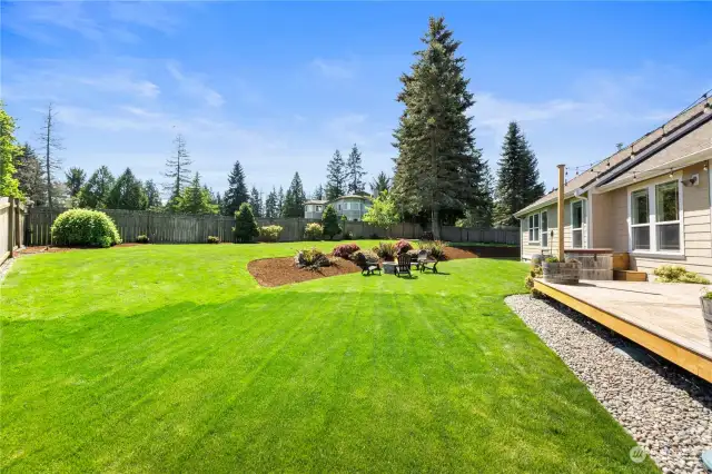 The lushly landscaped, fully fenced back yard is the perfect space for play & relaxation.