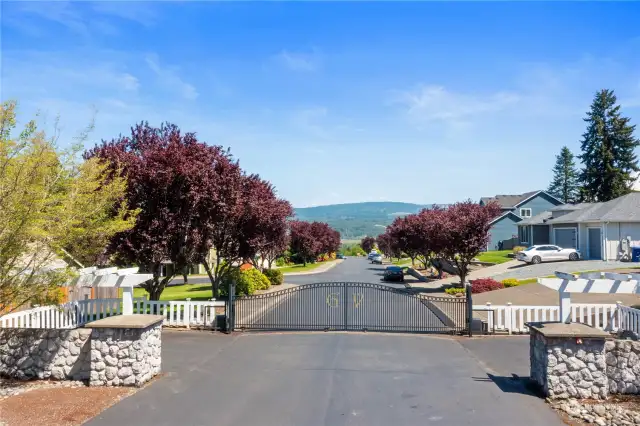 Enjoy the perks of living in this securely gated & lovely, large lot community