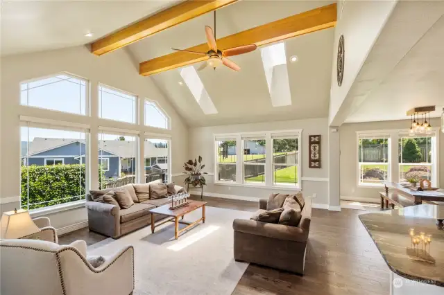The open concept living area features a vaulted ceiling, wood beams & expansive windows that provide natural light and amazing views. The majority of the interior has been freshly painted