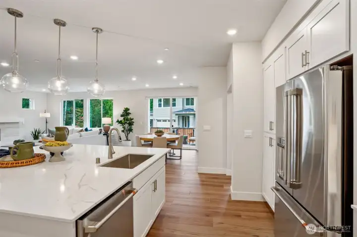 Large single basin sink.  Upgraded quartz countertop & pendant lights.  LVP on the entire main floor and stairs and upper hallway.