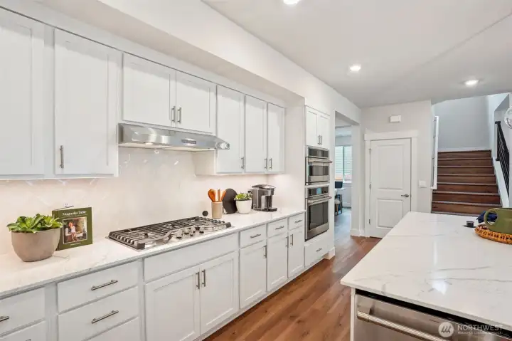 Gorgeous!  Beautiful full height backsplash and such a beautiful compliment to the quartz counter slab.