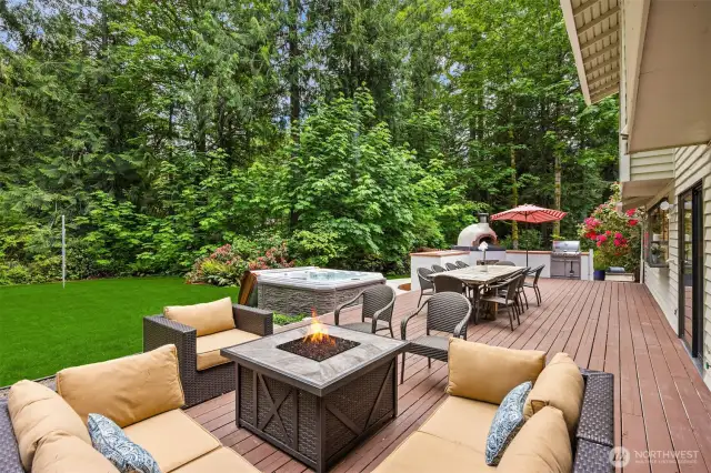 Massive deck with outdoor dining and living overlooking completely private and level backyard.