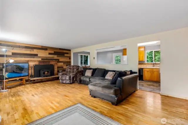 Living room with wood stove and original hardwood floors