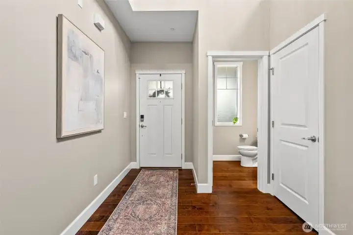 POV - looking at the front door with powder room for guests on the main.
