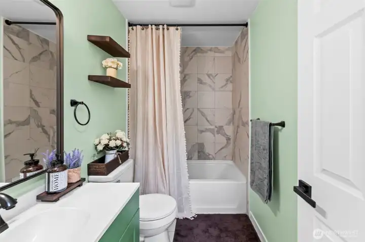 Full bathroom located downstairs with high ceilings