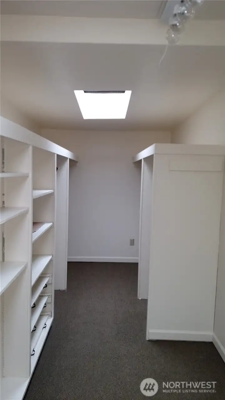 Walk-in closet by main bedroom