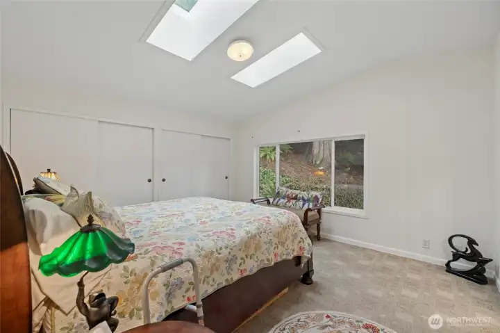 Primary bedroom with double closets and skylights