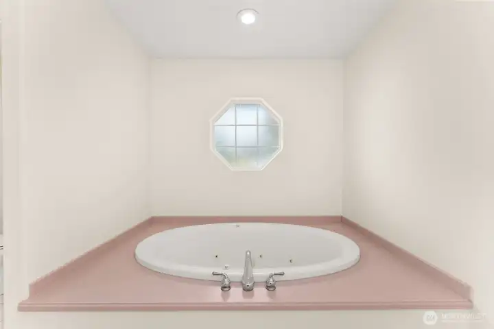 Relaxing jetted soaking tub in the primary bath
