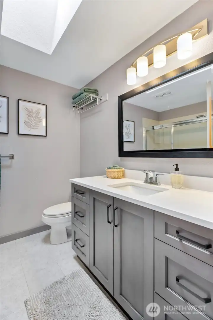 Main bathroom with double sinks, skylight and so much more!