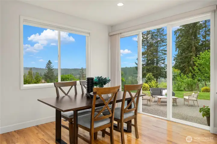 Spacious kitchen dining area is flooded with light and features northeast Cascade views and seamless flow to backyard patio for entertaining and barbecuing.
