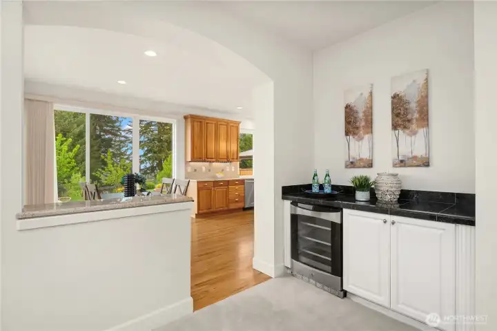 Easy access to the family room from the kitchen is convenient. Room features a granite serving counter with built-in beverage cooler.  After enjoying some outdoor activities, guests can come in through slider to the family room.