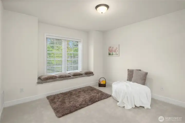 Additional bedroom is part of a Jack and Jill suite.  This room has it's own custom window seat.  The bedroom has been partially staged to show that the room is large enough for a bed and a special reading nook.