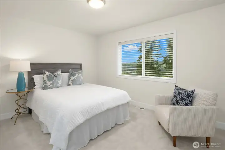 Second bedroom as part of Jack and Jill suite features northeast Cascade views and overlooks backyard and green space.  Room is spacious enough for a queen sized bed and a chair.