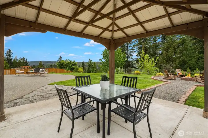 The flow from the patio to the gazebo and from the gazebo to the fire pit is perfect for hosting gatherings and special occasions. If you like to entertain family and friends, this backyard is the oasis everyone will love!