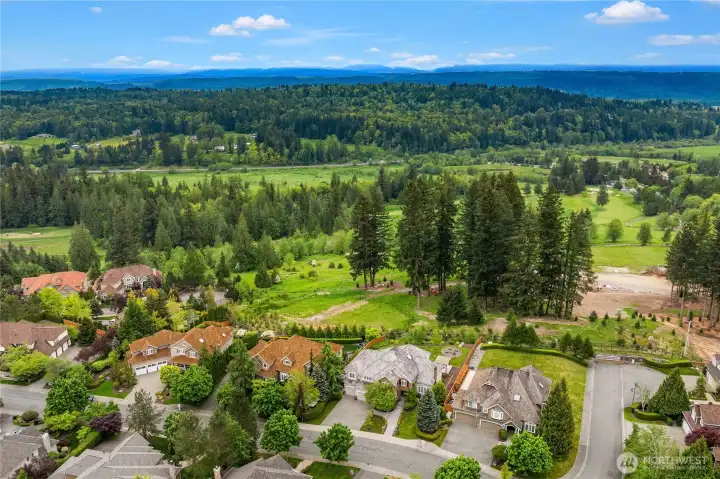 Aerial photo shows Aldarra Golf Course to the east and territorial Cascade mountain views.  On a clear day, this view is spectacular from the backyard and from most east facing rooms in the home.