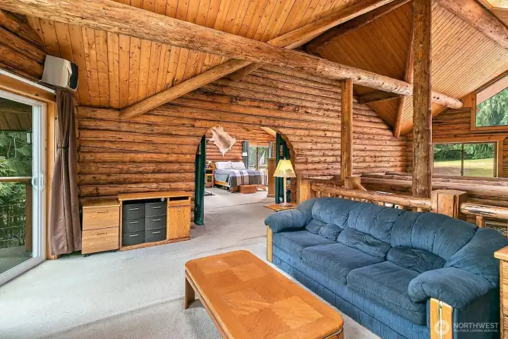 Upstiars loft with access to the primary bedroom and a slider to the deck. Upstiars loft with access to the primary bedroom and a slider to the deck.