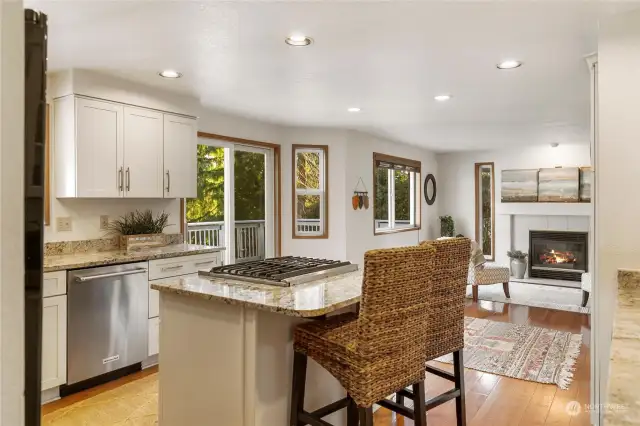 Such an inviting flow for the heart of the home! Bay window in the breakfast nook leads out to an oversized deck