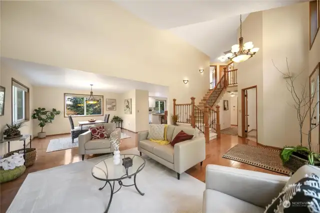 The elegant formal living room boasts a vaulted ceiling and stunning solid red oak wide plank flooring on the main level.