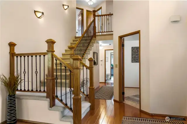 Custom wood banister railings with cast iron balusters.