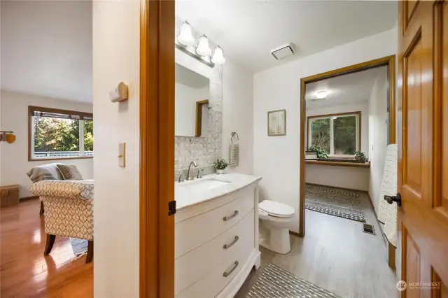 The spacious laundry room, just beyond the main floor half bath, is oversized with more than enough room to comfortably fold and store clothes.