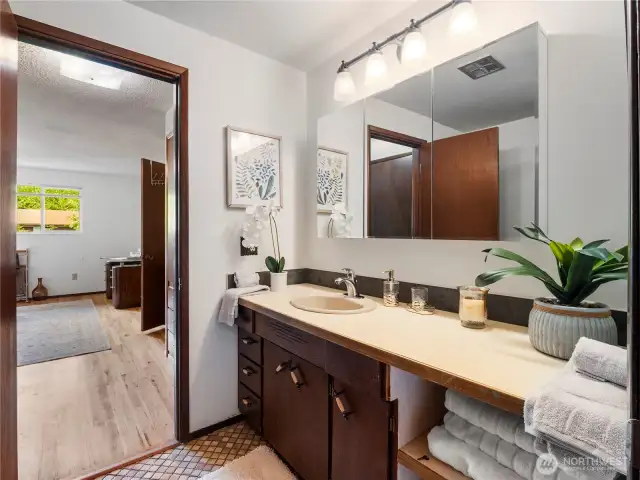 The primary bathroom is a 3/4th with cute tile floor.