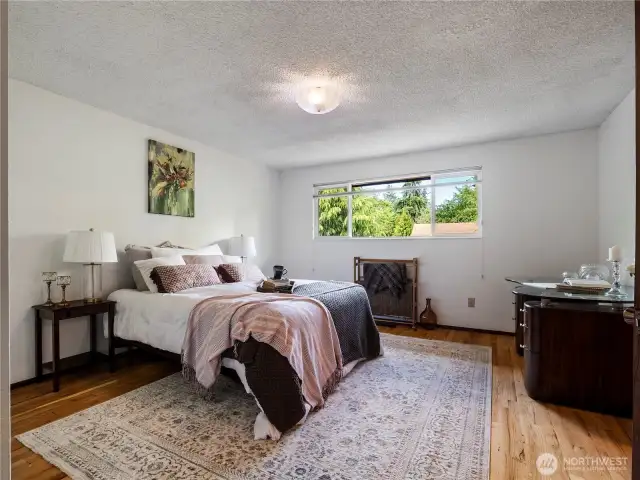 Primary bedroom is ample size and is privately located on the front side of the home.