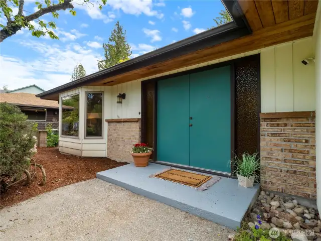 The green double doors invite you in to the home.