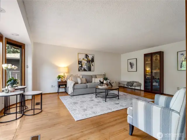 The large  living room has original hardwood floors and fresh paint make this feel fresh. The large garden window let's in tons of natural light and make the space bright.