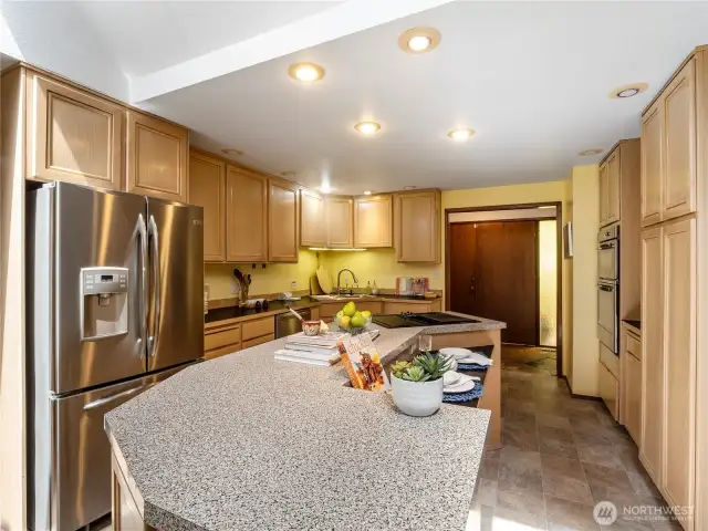The large island gives you plenty of space to work. You can also belly up to the bar and have your breakfast while the cook prepares your meal.