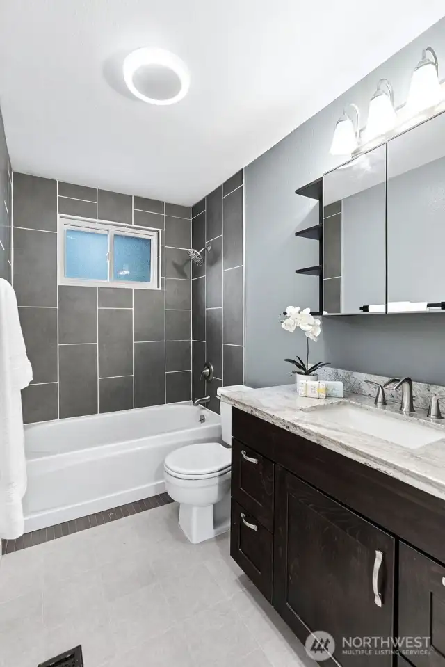 Updated lighting fresh paint and granite topped  vanity