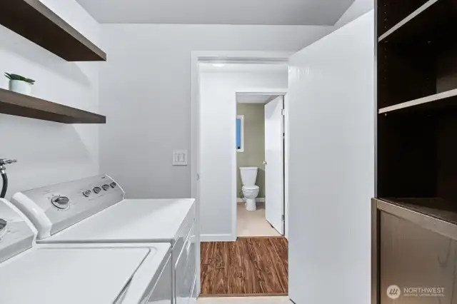 Laundry/utility room with modern shelving includes the washer & dryer