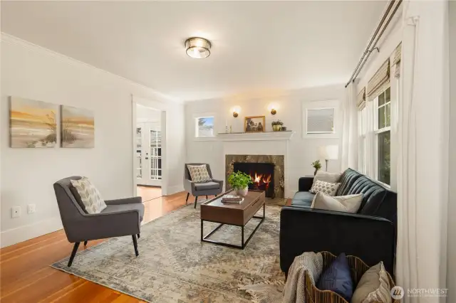 Cozy light-filled living room to curl up by the fireplace.