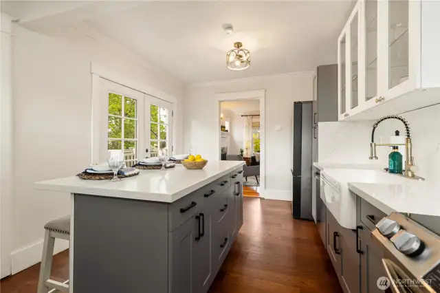Plenty of cabinets - what a great kitchen to cook delicious meals! Two places to eat: the island or through the French doors on the deck!