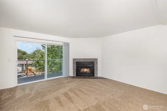 Fireplace adds warmth to the living room with large sliding door leading to the private balcony.